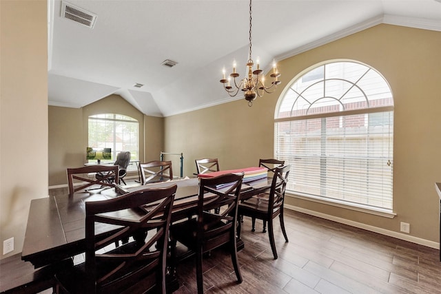 1431 Hidden Terrace Dr, Sugar Land, TX 77479 - dining area featuring vaulted ceiling, a chandelier, wood finished floors, and ornamental molding