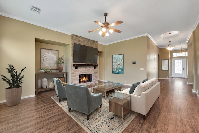 1431 Hidden Terrace Dr, Sugar Land, TX 77479 - living area with wood finished floors, crown molding, a stone fireplace, and ceiling fan