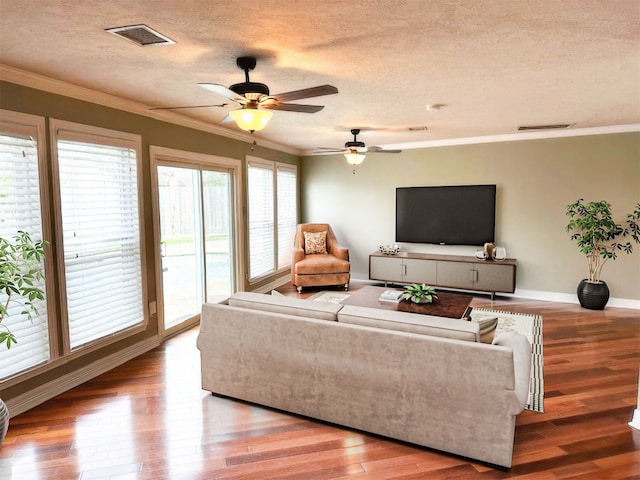 2907 Arrowhead Dr, Sugar Land, TX 77479 - living area with wood finished floors, ceiling fan, crown molding, and a textured ceiling