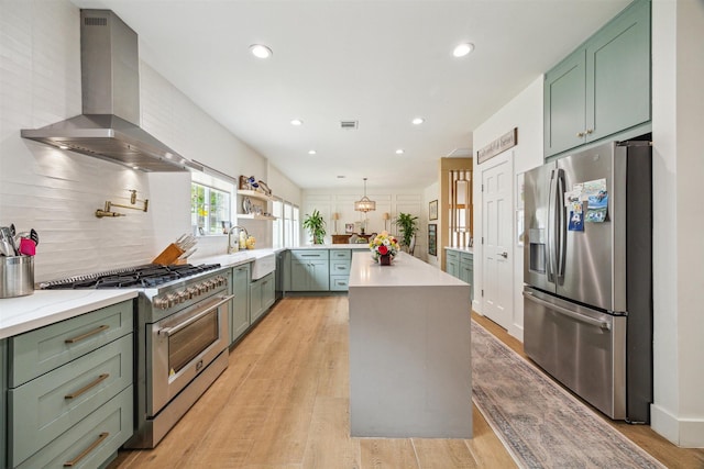 1215 Heathwood Dr, Houston, TX 77077 - kitchen with stainless steel appliances, island range hood, green cabinetry, decorative backsplash, and recessed lighting