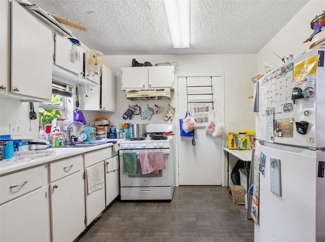 4820 Palmetto St, Bacliff, TX 77518 - kitchen featuring white appliances, light countertops, a textured ceiling, under cabinet range hood, and white cabinetry