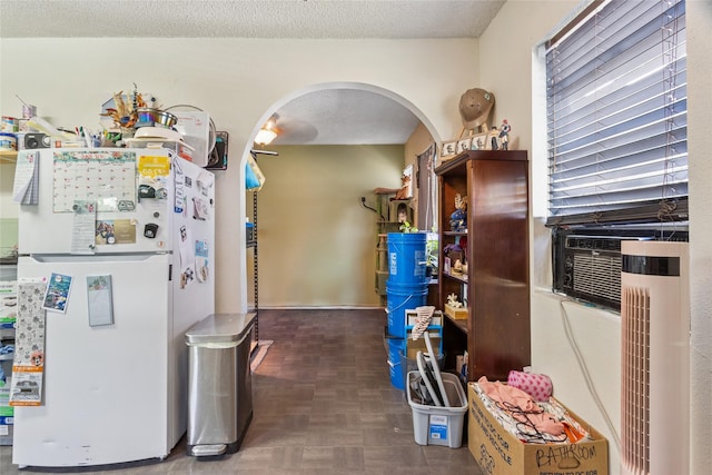 4820 Palmetto St, Bacliff, TX 77518 - kitchen with freestanding refrigerator, arched walkways, and a textured ceiling