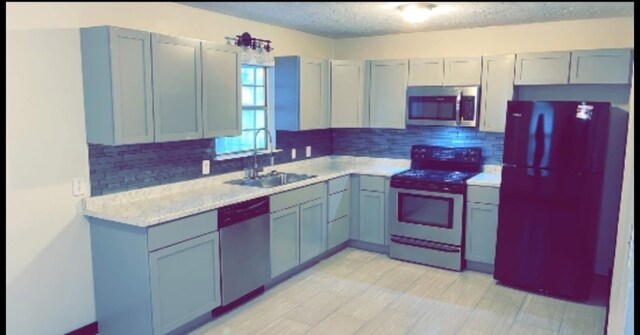 3661 Fm 3277, Livingston, TX 77351 - kitchen with stainless steel appliances, light countertops, tasteful backsplash, and a textured ceiling