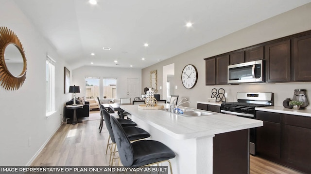 5446 Pinetree Crescent Ln, Spring, TX 77373 - kitchen featuring stainless steel appliances, light countertops, light wood finished floors, recessed lighting, and vaulted ceiling