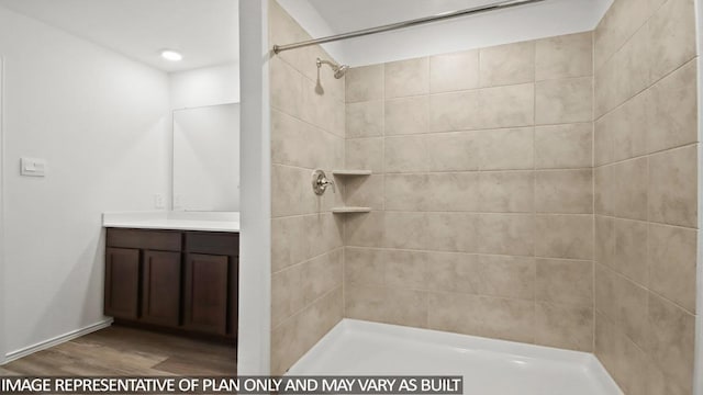 5446 Pinetree Crescent Ln, Spring, TX 77373 - full bathroom featuring vanity, wood finished floors, and tiled shower