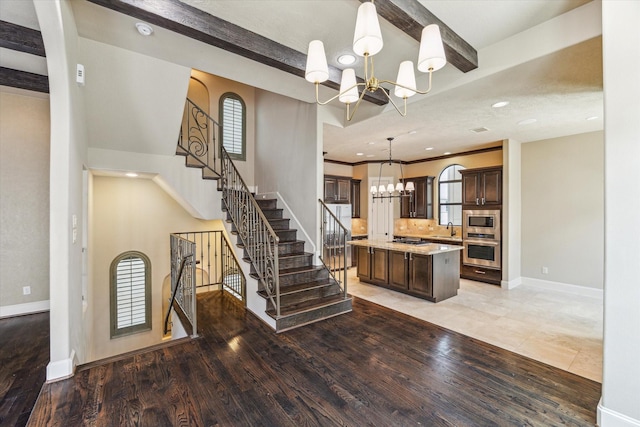 506 Knox St Unit A, Houston, TX 77007 - kitchen with appliances with stainless steel finishes, a chandelier, dark brown cabinetry, a kitchen island, and pendant lighting