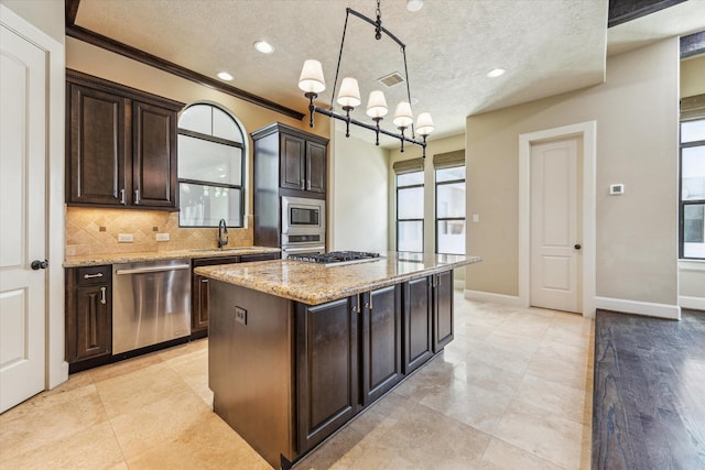 506 Knox St Unit A, Houston, TX 77007 - kitchen with appliances with stainless steel finishes, tasteful backsplash, a chandelier, plenty of natural light, and a textured ceiling