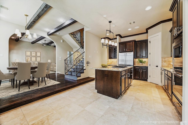 506 Knox St Unit A, Houston, TX 77007 - kitchen featuring a ceiling fan, built in appliances, tasteful backsplash, a center island, and a chandelier