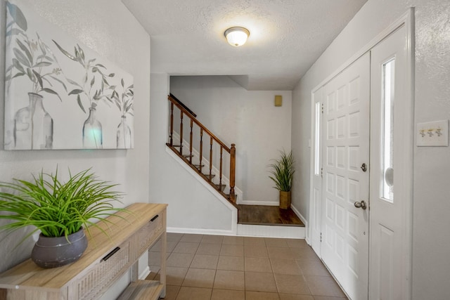 8415 Sparkling Springs Dr, Houston, TX 77095 - tiled entrance foyer with a textured ceiling and stairway