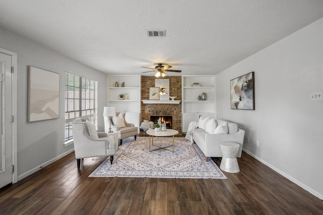 8415 Sparkling Springs Dr, Houston, TX 77095 - living room featuring ceiling fan, a brick fireplace, dark wood finished floors, a textured ceiling, and built in features