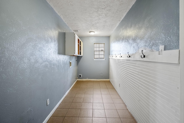 8415 Sparkling Springs Dr, Houston, TX 77095 - laundry area featuring tile patterned flooring, a textured ceiling, and hookup for a washing machine