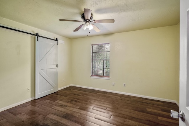 8415 Sparkling Springs Dr, Houston, TX 77095 - unfurnished bedroom featuring a barn door, dark wood-style flooring, a textured ceiling, and ceiling fan