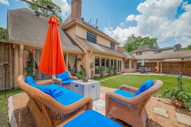 12214 Clearfork Dr, Houston, TX 77077 - back of house with an outdoor hangout area, roof with shingles, a patio, a chimney, and board and batten siding