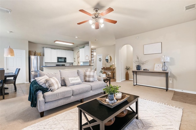 24602 Lakecrest Run Dr, Katy, TX 77493 - living room with arched walkways, light carpet, and ceiling fan