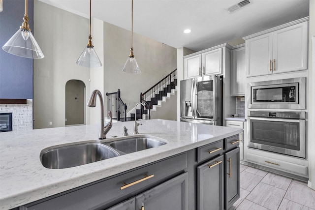 4511 Hickory Branch Ln, Sugar Land, TX 77479 - kitchen featuring stainless steel appliances, backsplash, light stone countertops, pendant lighting, and recessed lighting