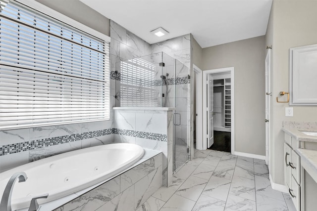 4511 Hickory Branch Ln, Sugar Land, TX 77479 - bathroom featuring a shower stall, a jetted tub, vanity, marble look tiles, and a walk in closet