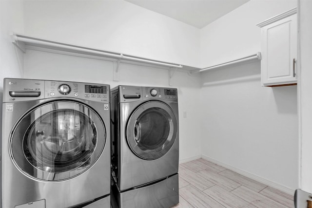 4511 Hickory Branch Ln, Sugar Land, TX 77479 - washroom with independent washer and dryer, cabinet space, and light wood finished floors