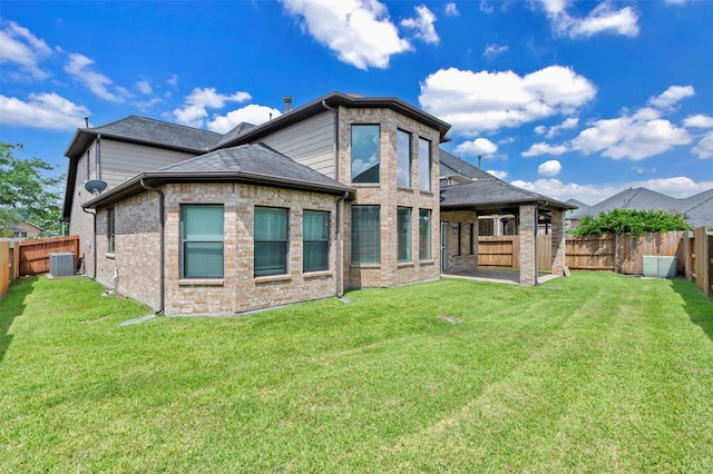 4511 Hickory Branch Ln, Sugar Land, TX 77479 - back of property featuring a fenced backyard, brick siding, and roof with shingles