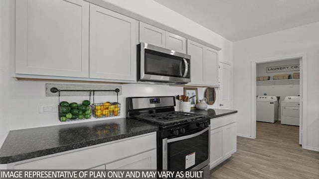 5442 Pinetree Crescent Ln, Spring, TX 77373 - kitchen with appliances with stainless steel finishes, washer and clothes dryer, white cabinetry, and light wood finished floors