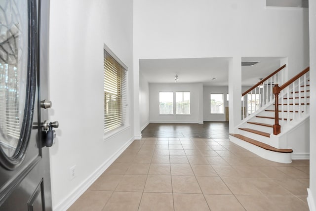 9226 Wichita Dr, La Porte, TX 77571 - entryway with light tile patterned flooring, stairs, and a towering ceiling