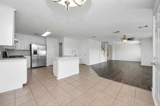 9226 Wichita Dr, La Porte, TX 77571 - kitchen with stainless steel fridge, light countertops, a ceiling fan, and open floor plan