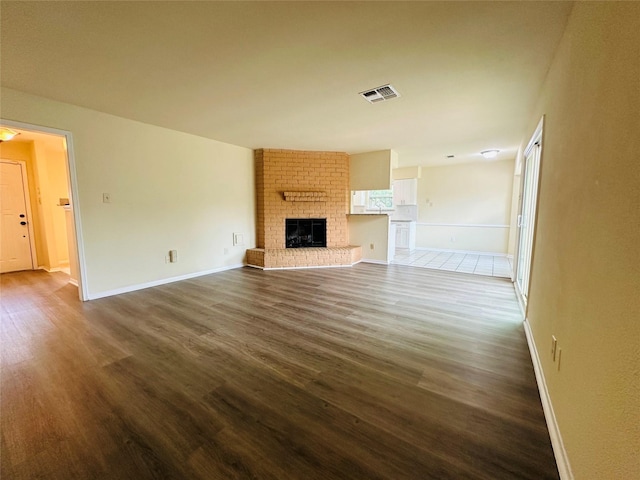 15474 Peermont St, Houston, TX 77062 - unfurnished living room featuring dark wood finished floors and a brick fireplace