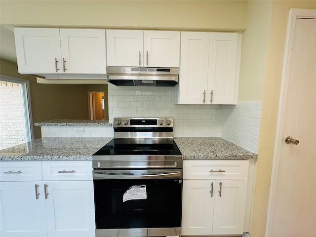 15474 Peermont St, Houston, TX 77062 - kitchen featuring under cabinet range hood, stainless steel range with electric cooktop, white cabinetry, decorative backsplash, and light stone countertops