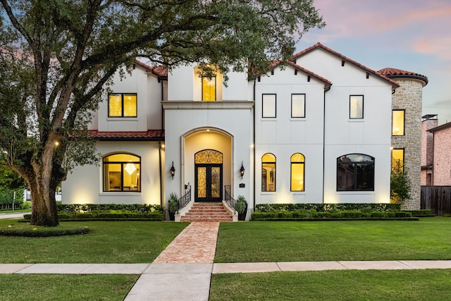 5201 Pine St, Bellaire, TX 77401 - mediterranean / spanish-style home with french doors, a tiled roof, and a yard