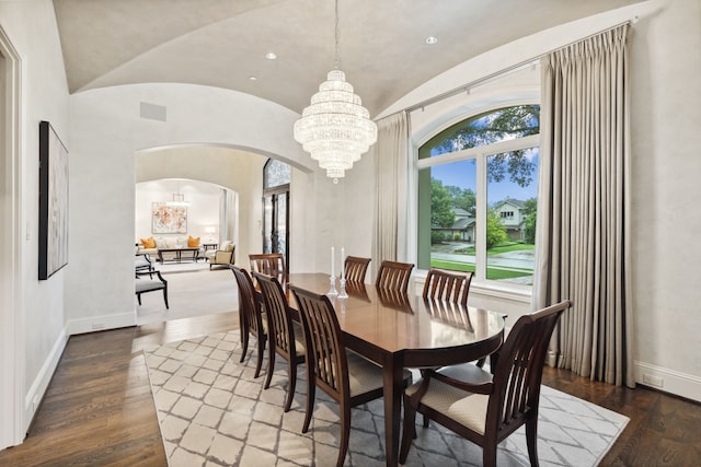 5201 Pine St, Bellaire, TX 77401 - dining area featuring arched walkways, lofted ceiling, a chandelier, wood finished floors, and recessed lighting
