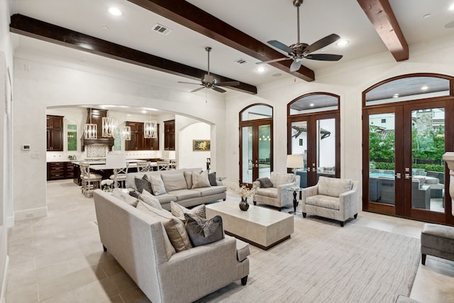 5201 Pine St, Bellaire, TX 77401 - living area with french doors, arched walkways, beam ceiling, a ceiling fan, and light tile patterned floors