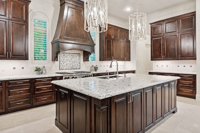 5201 Pine St, Bellaire, TX 77401 - kitchen with a chandelier, decorative backsplash, an island with sink, pendant lighting, and light stone counters