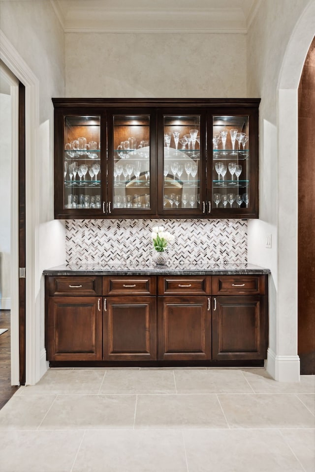 5201 Pine St, Bellaire, TX 77401 - bar with arched walkways, ornamental molding, and tasteful backsplash