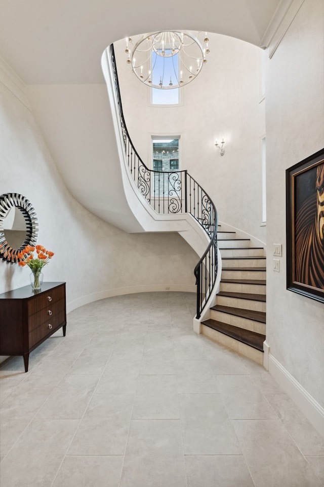 5201 Pine St, Bellaire, TX 77401 - stairs with a chandelier, tile patterned flooring, and a high ceiling