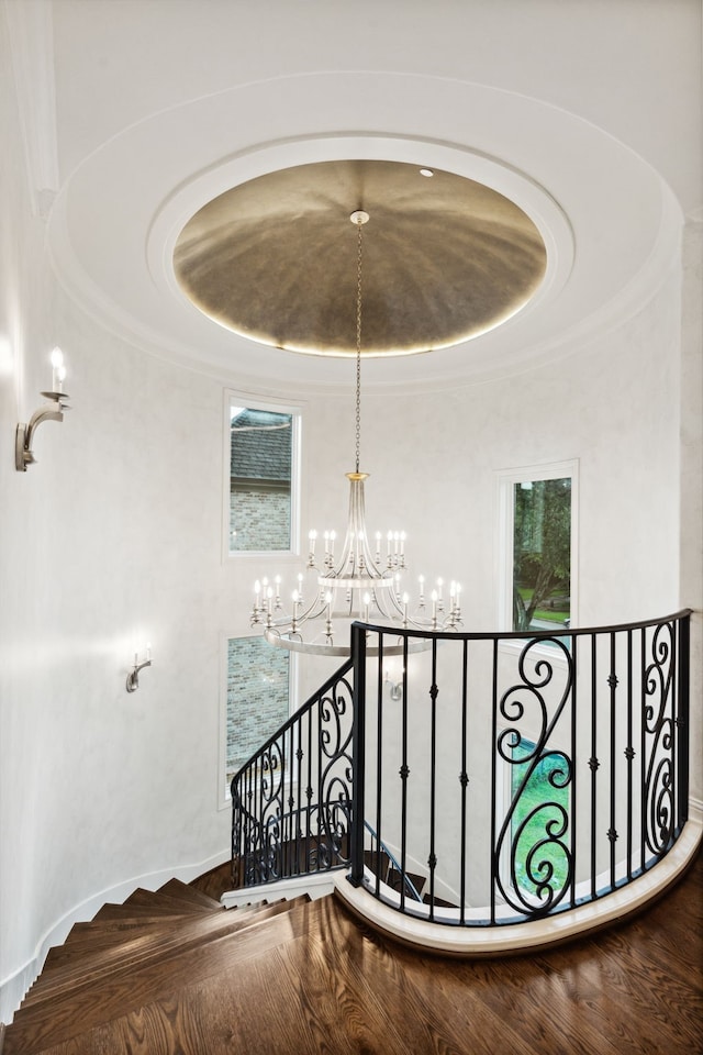 5201 Pine St, Bellaire, TX 77401 - stairway featuring a chandelier and a raised ceiling