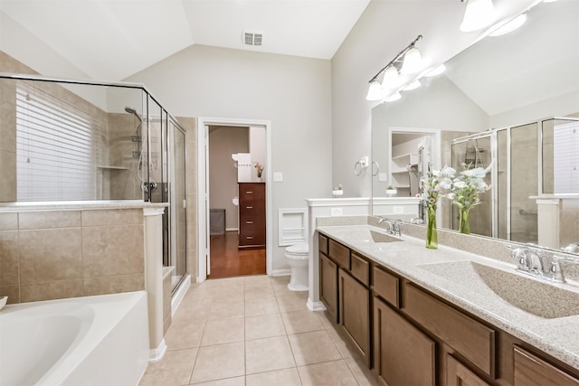 6903 Lamar Park Ln, Houston, TX 77049 - bathroom with lofted ceiling, tile patterned flooring, a stall shower, double vanity, and a garden tub