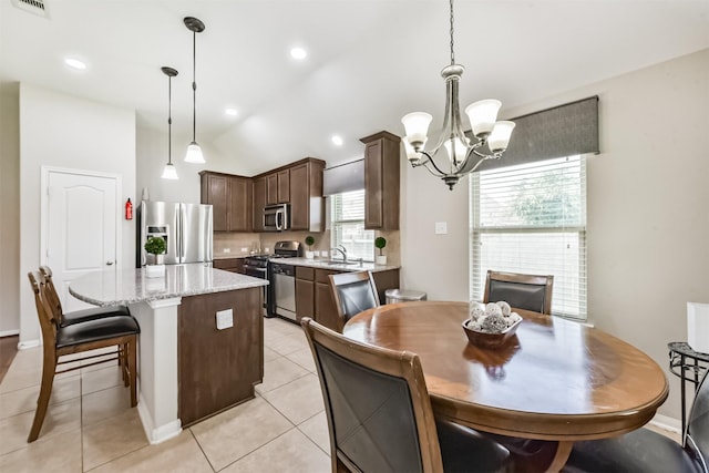 6903 Lamar Park Ln, Houston, TX 77049 - dining area with a chandelier, a fireplace, vaulted ceiling, and light tile patterned floors