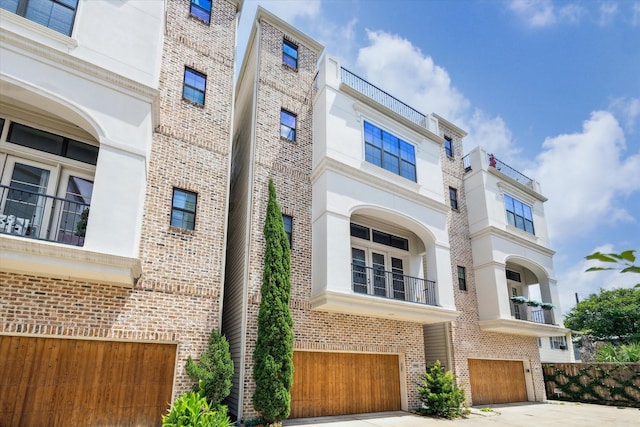 6018 Maxie St Unit B, Houston, TX 77007 - view of front of home with an attached garage, brick siding, and concrete driveway