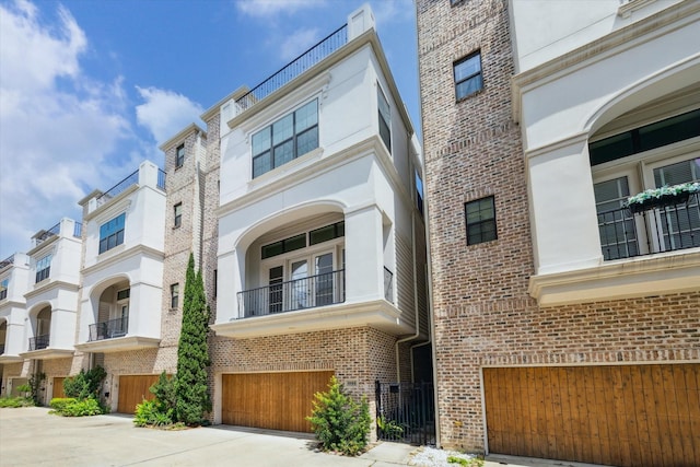 6018 Maxie St Unit B, Houston, TX 77007 - view of front facade featuring an attached garage, brick siding, and driveway