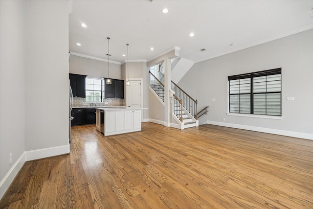 6018 Maxie St Unit B, Houston, TX 77007 - kitchen with open floor plan, light countertops, decorative backsplash, light wood-style flooring, and recessed lighting