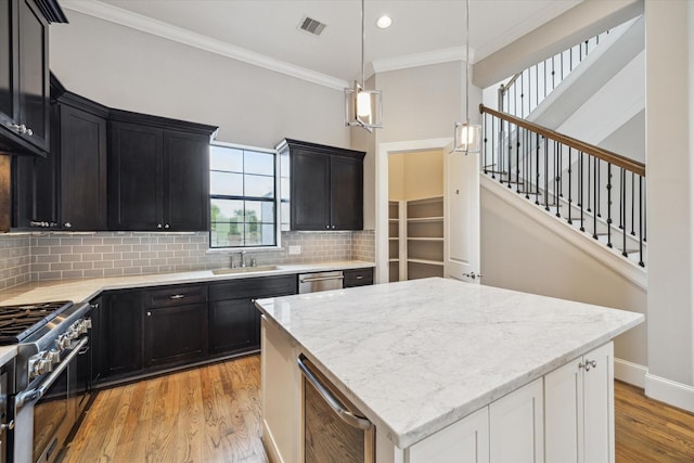 6018 Maxie St Unit B, Houston, TX 77007 - kitchen with appliances with stainless steel finishes, beverage cooler, ornamental molding, dark cabinetry, and backsplash