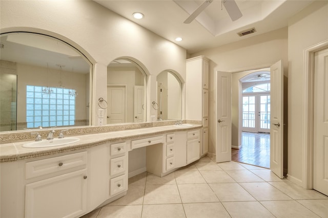 4035 Gramercy St, Houston, TX 77025 - bathroom featuring ceiling fan, double vanity, tile patterned flooring, recessed lighting, and a raised ceiling