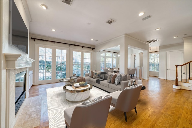 4035 Gramercy St, Houston, TX 77025 - living room featuring ornamental molding, recessed lighting, stairs, a premium fireplace, and light wood finished floors