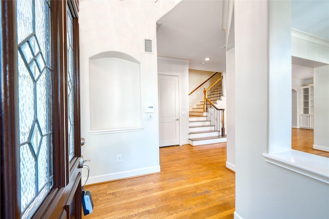 4035 Gramercy St, Houston, TX 77025 - entrance foyer featuring stairs, wood finished floors, recessed lighting, ornamental molding, and arched walkways