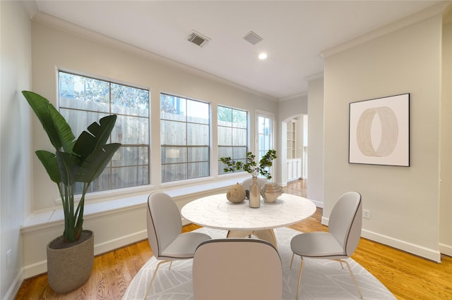 4035 Gramercy St, Houston, TX 77025 - dining area with ornamental molding, wood finished floors, arched walkways, and recessed lighting