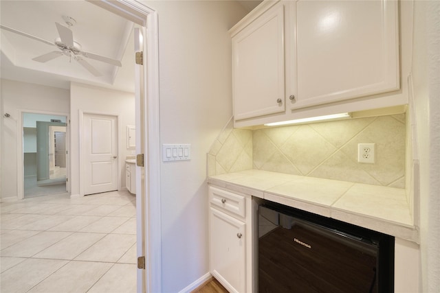 4035 Gramercy St, Houston, TX 77025 - bar area with wine cooler, decorative backsplash, light tile patterned floors, and a ceiling fan