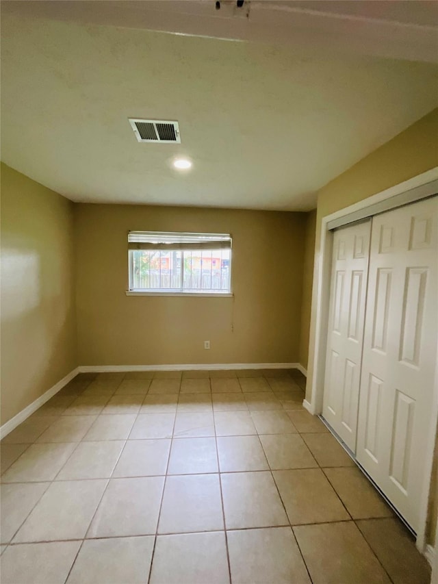 6404 Quail Meadow Dr, Houston, TX 77035 - unfurnished bedroom with light tile patterned floors, a closet, and recessed lighting