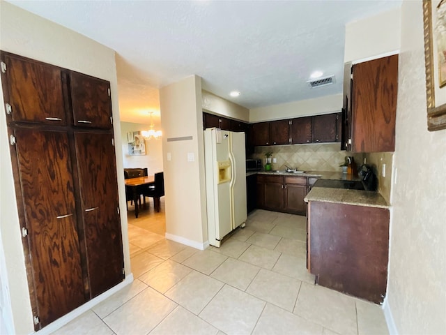 6404 Quail Meadow Dr, Houston, TX 77035 - kitchen featuring white refrigerator with ice dispenser, a chandelier, decorative backsplash, light tile patterned floors, and dark brown cabinets