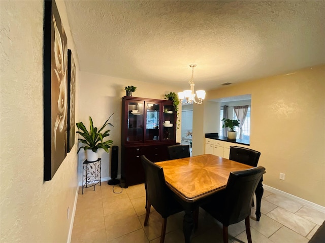 6404 Quail Meadow Dr, Houston, TX 77035 - dining area with a chandelier, light tile patterned flooring, a textured ceiling, and a textured wall