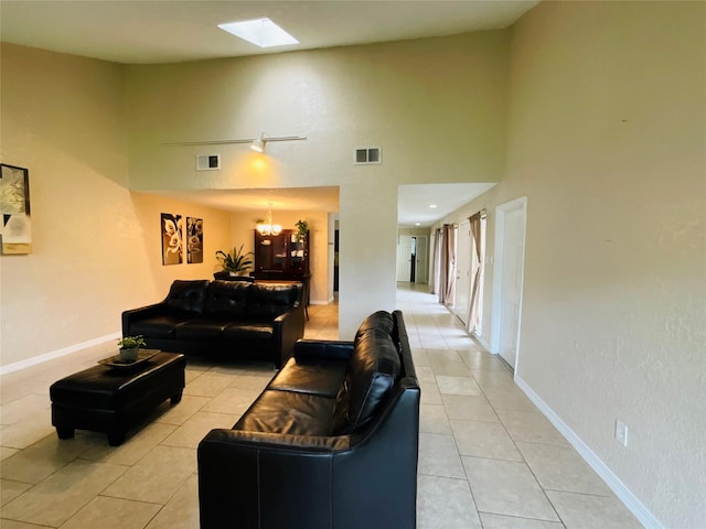 6404 Quail Meadow Dr, Houston, TX 77035 - living room featuring light tile patterned flooring, a chandelier, a skylight, and a towering ceiling