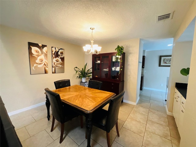 6404 Quail Meadow Dr, Houston, TX 77035 - dining area featuring a chandelier, light tile patterned flooring, and a textured ceiling